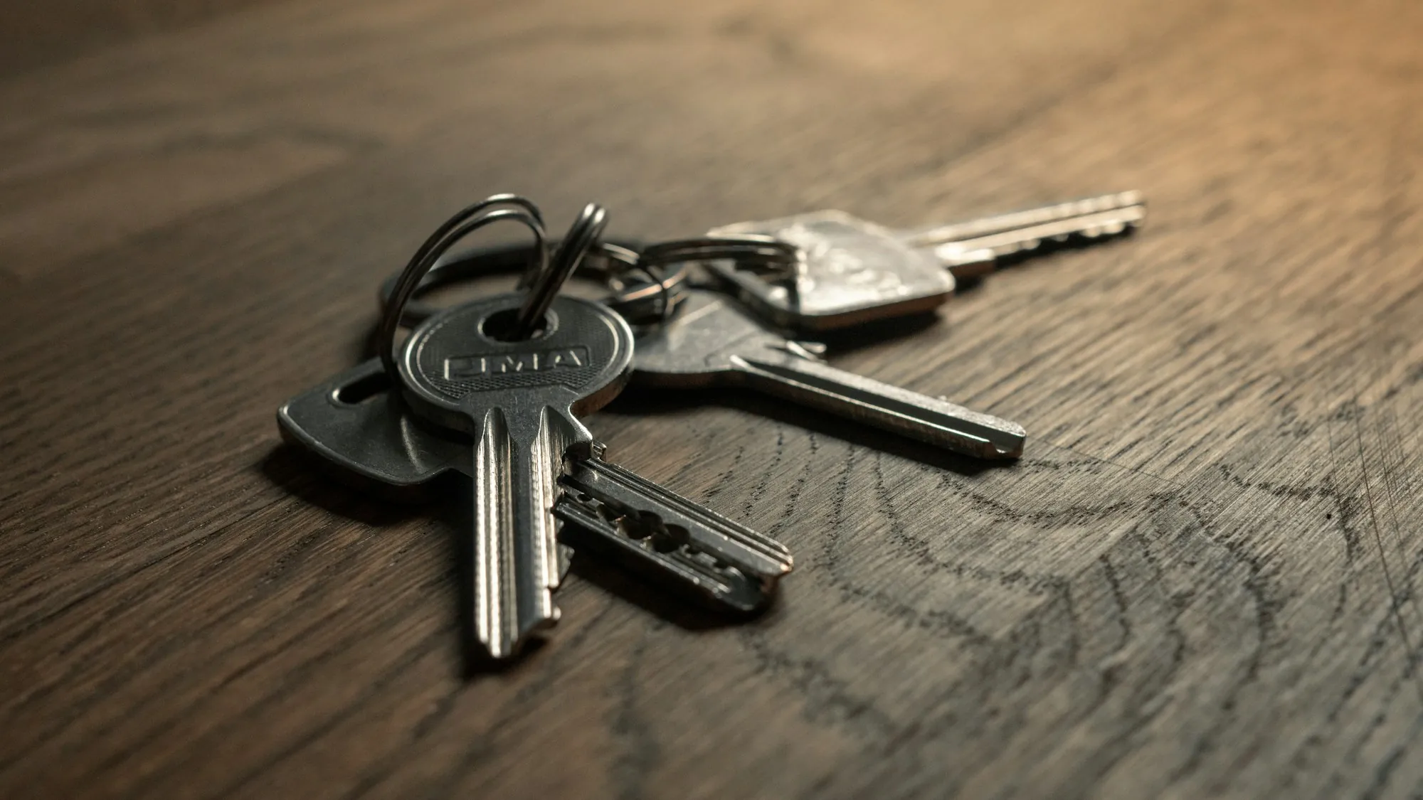 Set of house keys on a wooden surface