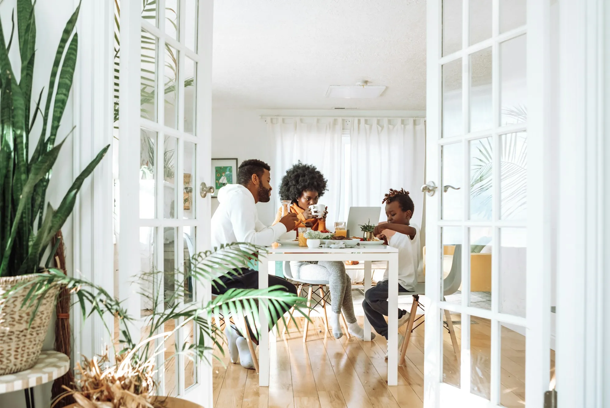 Family sitting around a dining table in a bright room, working out how much life insurance a Chicago family needs
