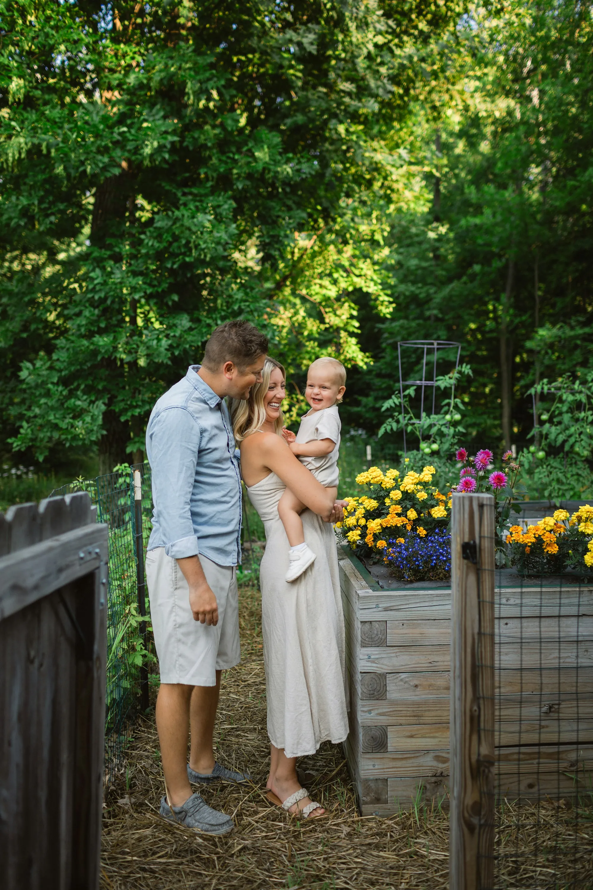 Couple in a garden holding their young daughter